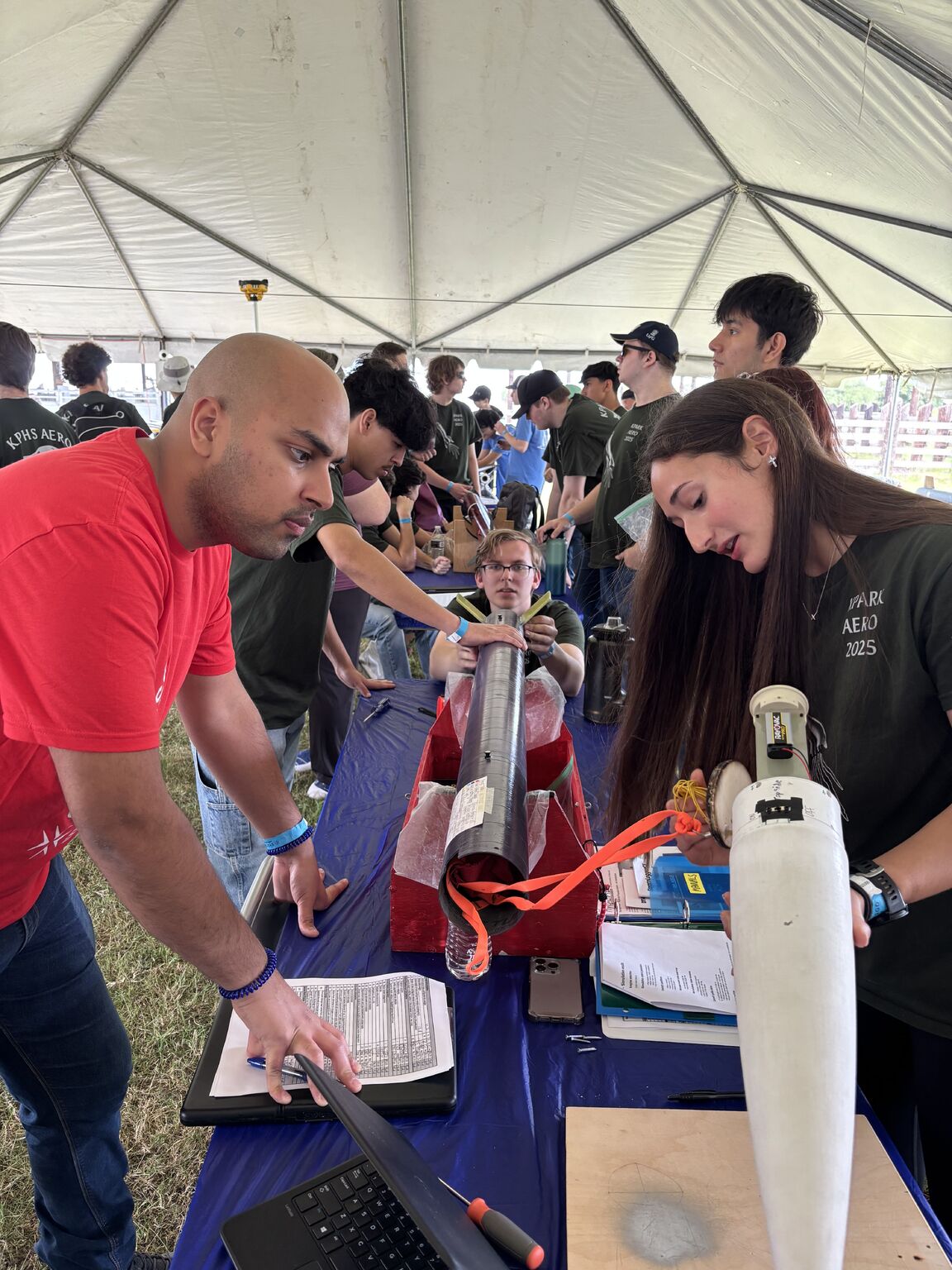 Shaleen reviewing rocket components with students